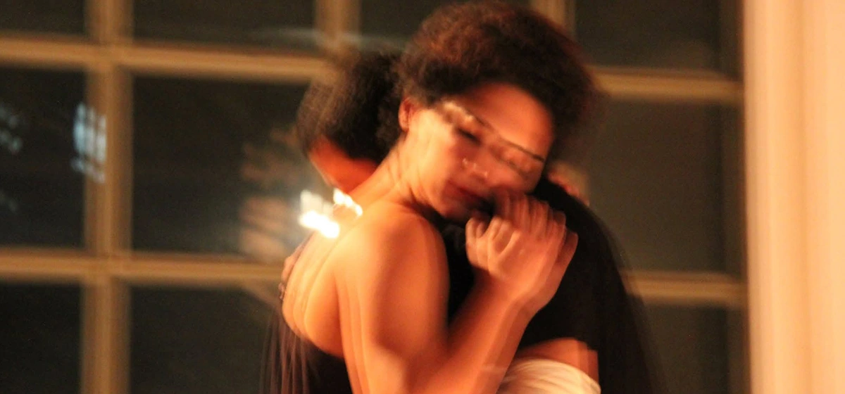 Actress Baharak Abdolifard performing in the play TAN holding her co-actor Nima Nazarinia in arms.
